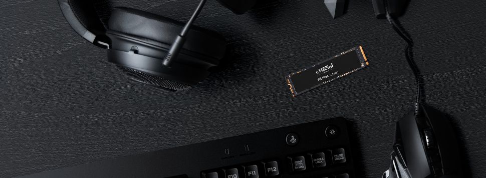 Crucial P5 Plus SSD with a headset,  mouse and keyboard